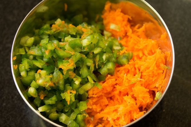 grated carrots and chopped bell pepper in a bowl