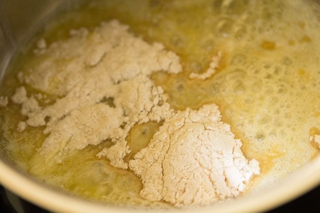 flour added to melted butter in pan for white sauce recipe. 