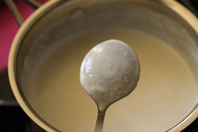 prepared béchamel sauce coating the back of the spoon. 