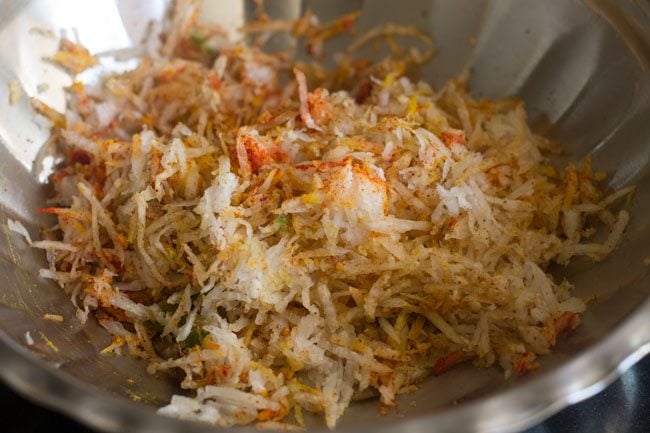 spices being mixed with radish