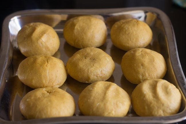 balls made from dough and set aside on a squared steel tray