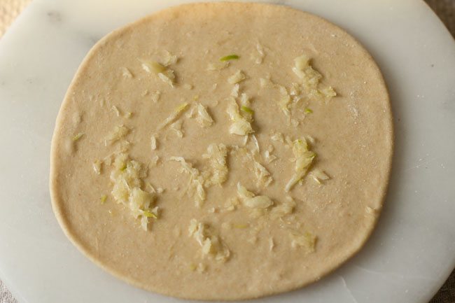 garlic paste spread on rolled disc. 