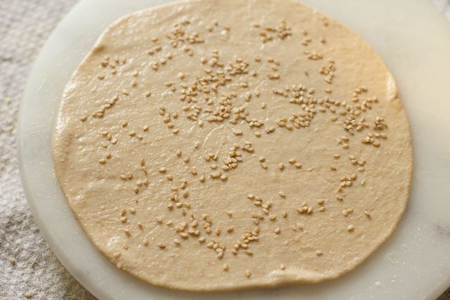 sesame seeds sprinkled all over the disc. 