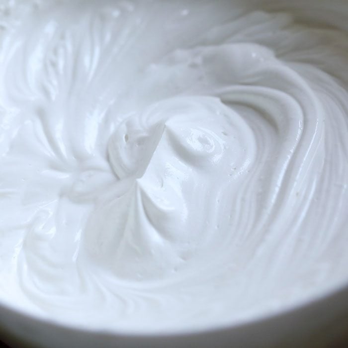 close up shot of whipped cream with stiff peaks in it for making mango ice cream from scratch