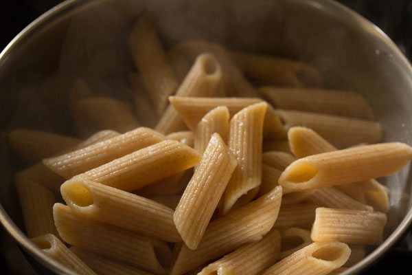 cooked penne pasta in a bowl. 