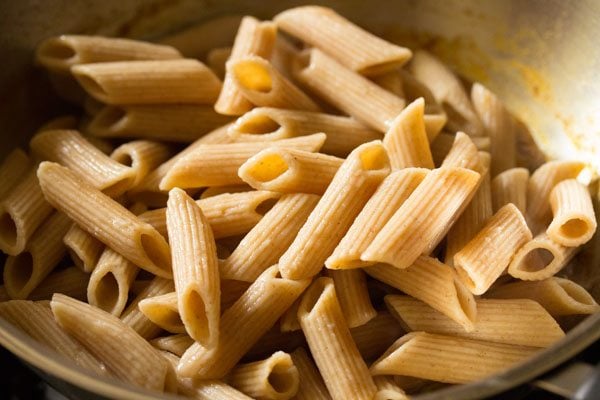 cooked penne pasta added to vegetable mixture. 