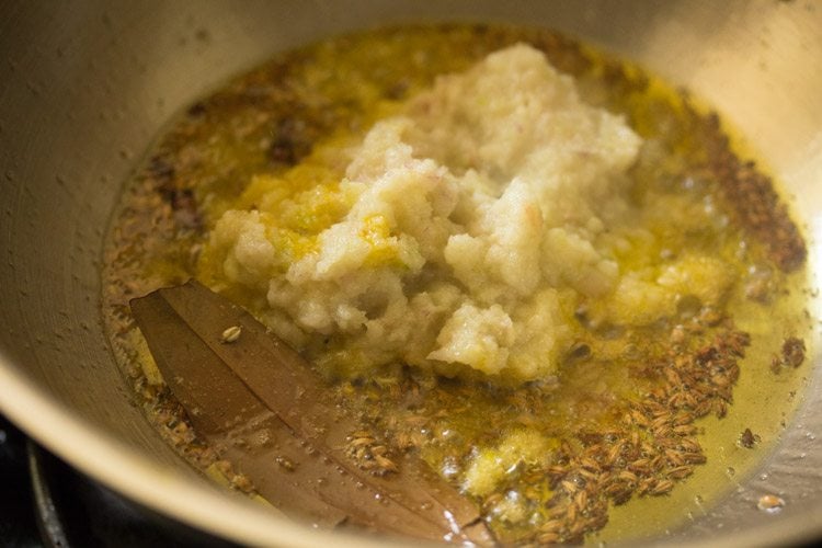 ground onion paste added to pan