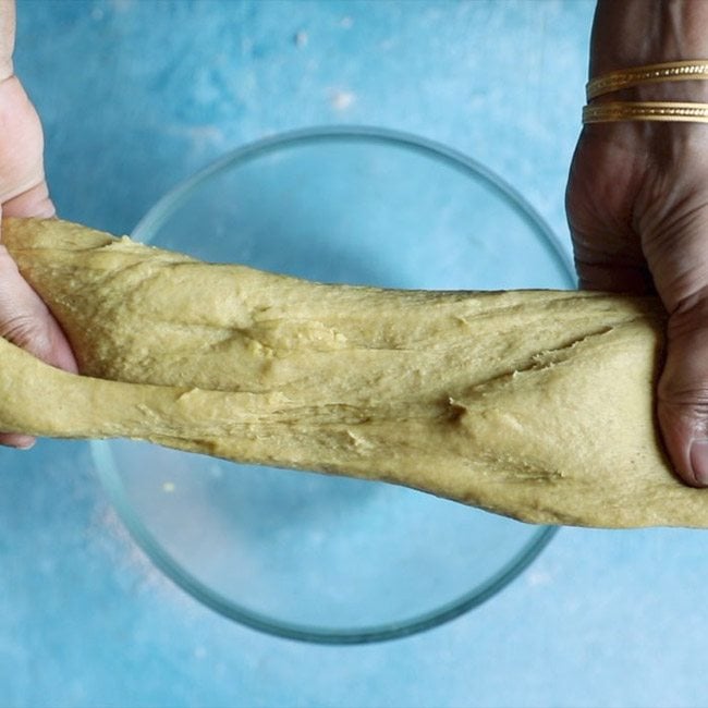 showing elasticity of holige recipe dough. 