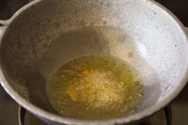 frying dals in hot ghee till golden. 