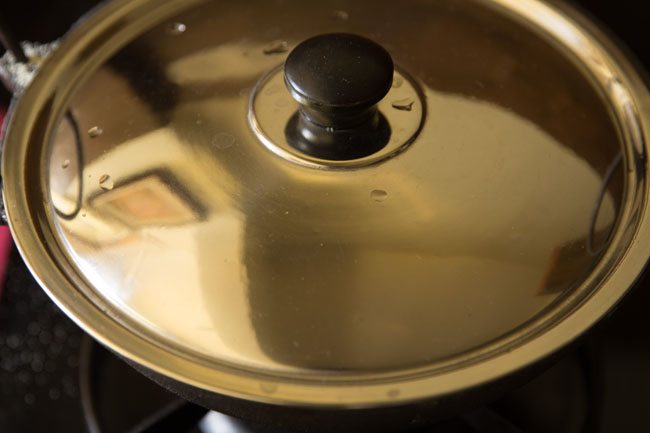 cooking rava kichadi in covered pan. 