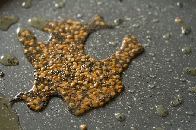 frying mustard seeds and black gram in hot oil. 