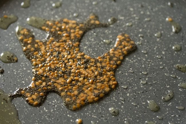 frying mustard seeds and black gram in hot oil. 