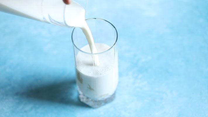 pouring milk in glass. 