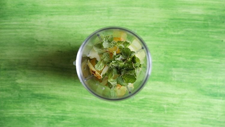 chopped roasted mangoes, herbs, seasonings in blender