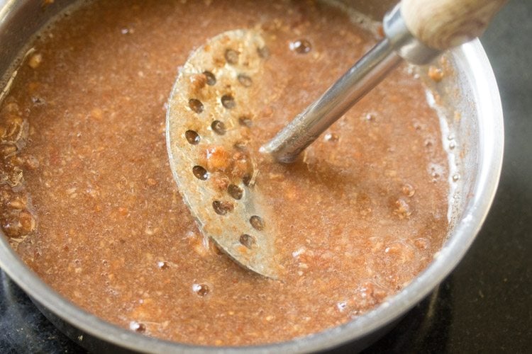 mashing fruit pulp with a vegetable masher. 