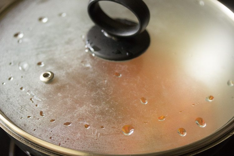 cooking carrot poriyal in the covered pan. 