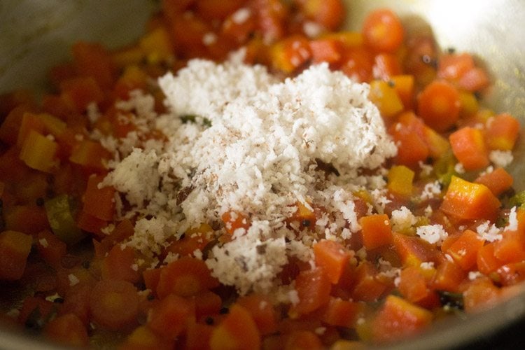 grated fresh coconut added to cooked carrot poriyal. 