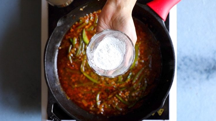 hand holding small bowl of cornstarch