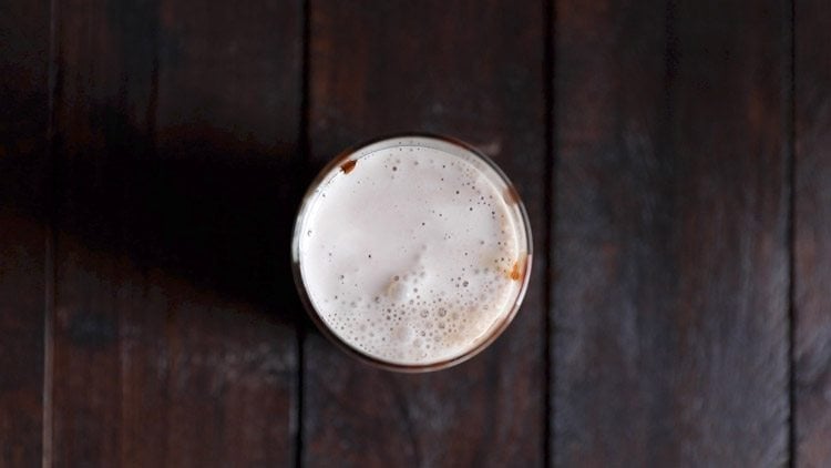 chocolate milkshake poured in prepared glasses. 