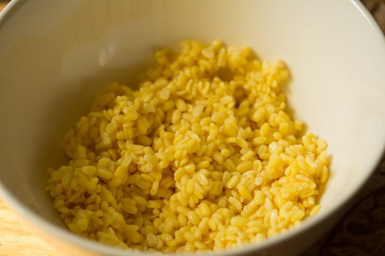 soaked and drained moong dal added to a bowl. 