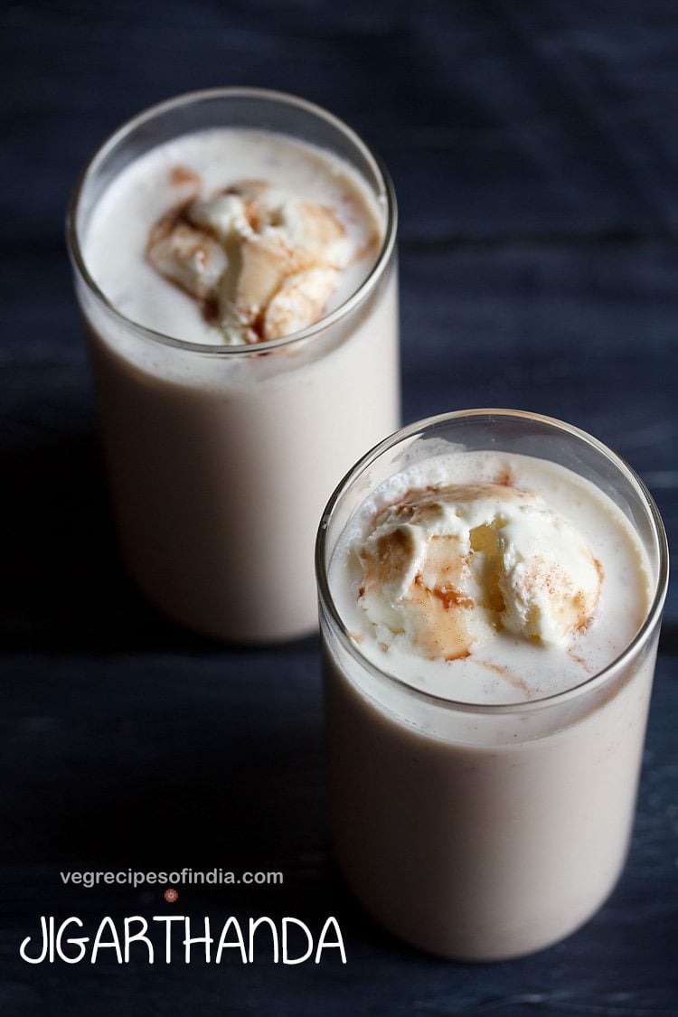 jigarthanda topped with vanilla ice cream in 2 serving glasses with text layovers.