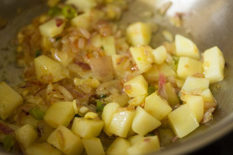 sautéing potatoes in pan.