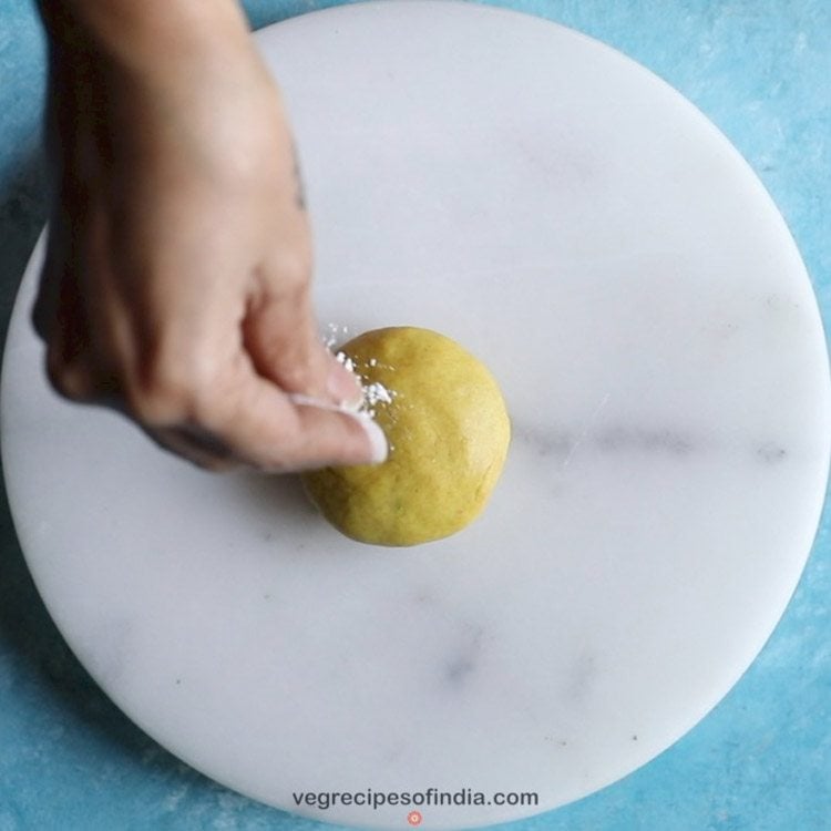 sprinkling flour on prepared bobbatlu recipe. 