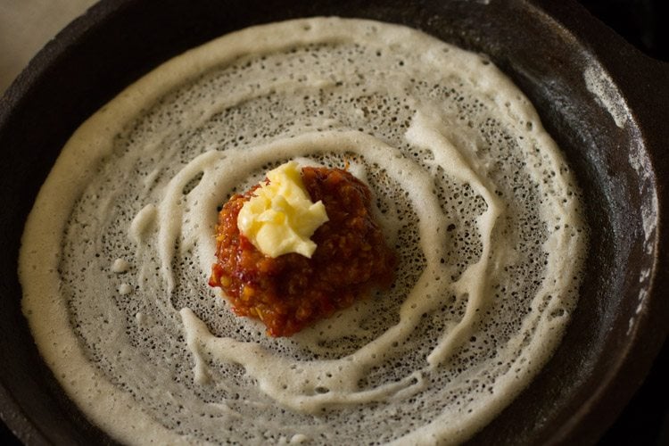 schezwan sauce and butter added on top of the dosa. 