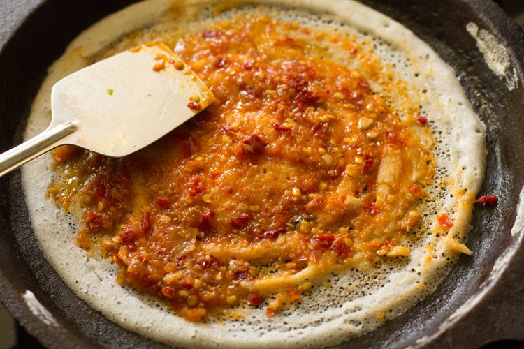 butter and schezwan sauce spread on the dosa. 