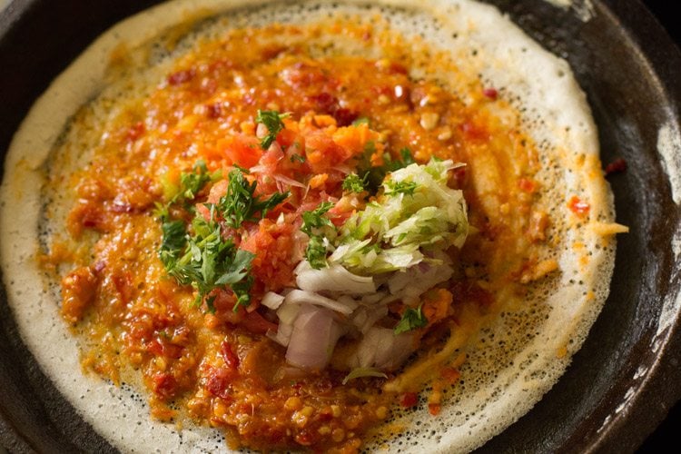 chopped vegetables and chopped coriander leaves add on the schezwan dosa. 