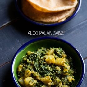 palak ki sabji served in a ceramic bowl with a ceramic plate of pooris kept on top side and text layovers.