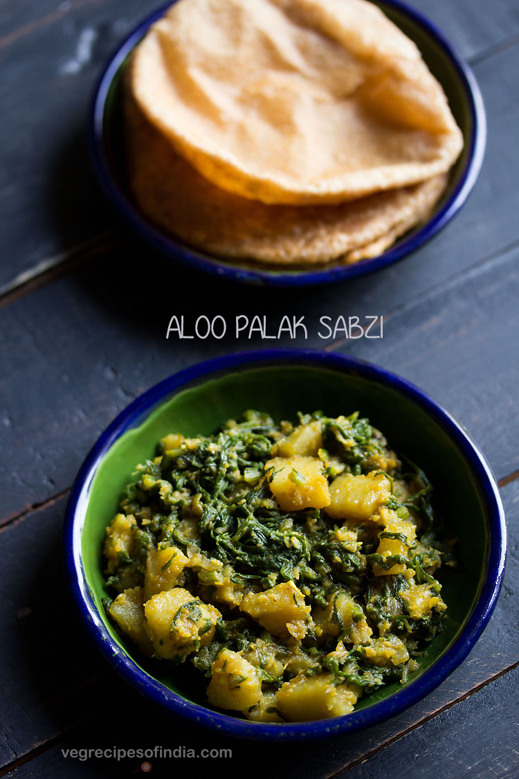 palak ki sabji served in a ceramic bowl with a ceramic plate of pooris kept on top side and text layovers.