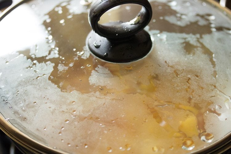 cooking potatoes in the covered pan. 