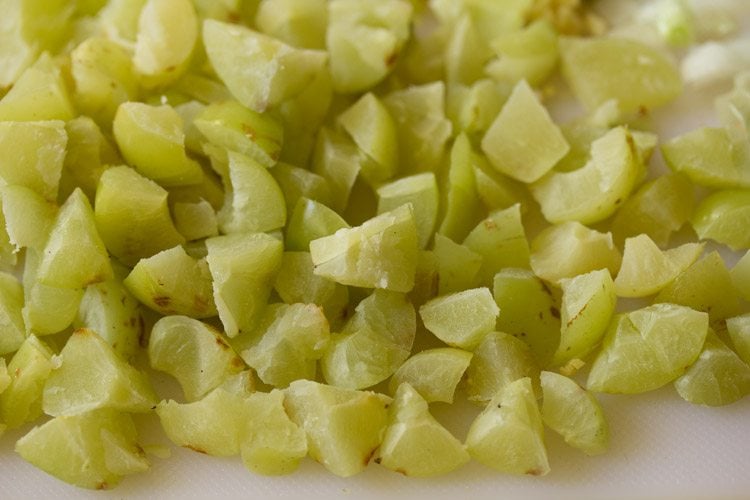 chopping amla and removing the seeds.