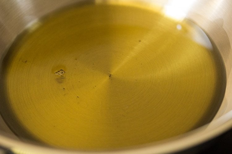 heating sesame oil in a pan for amla pickle.