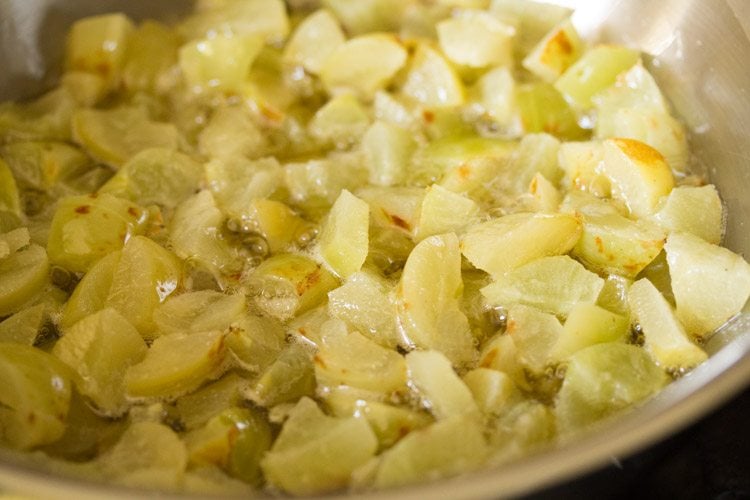 mixing the chopped amla in oil. 