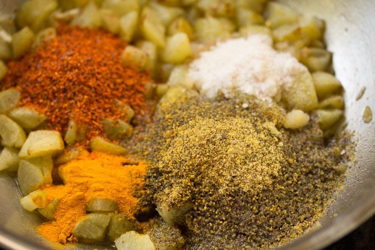 ed chili powder, turmeric powder, salt and ground spice mixture added to the amla pieces in the pan.