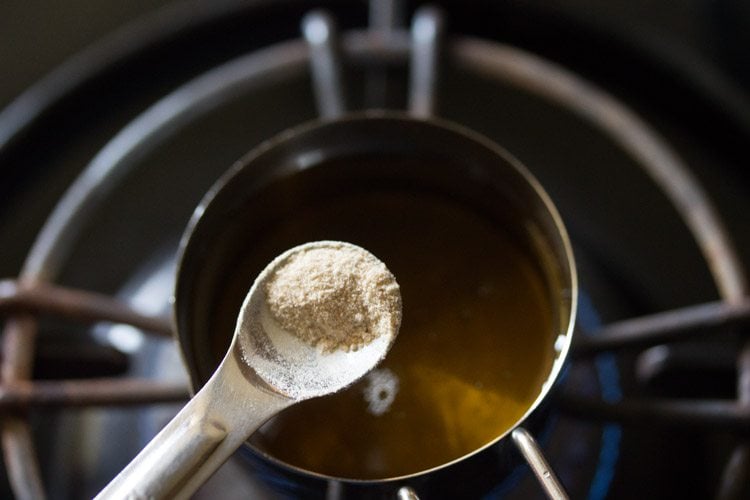 adding asafoetida to the hot oil.