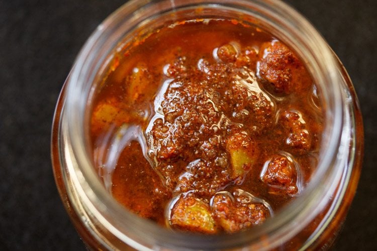 oil floating on top of the amla achar in the jar.