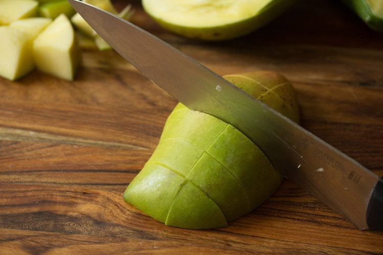 chopping unripe mangoes