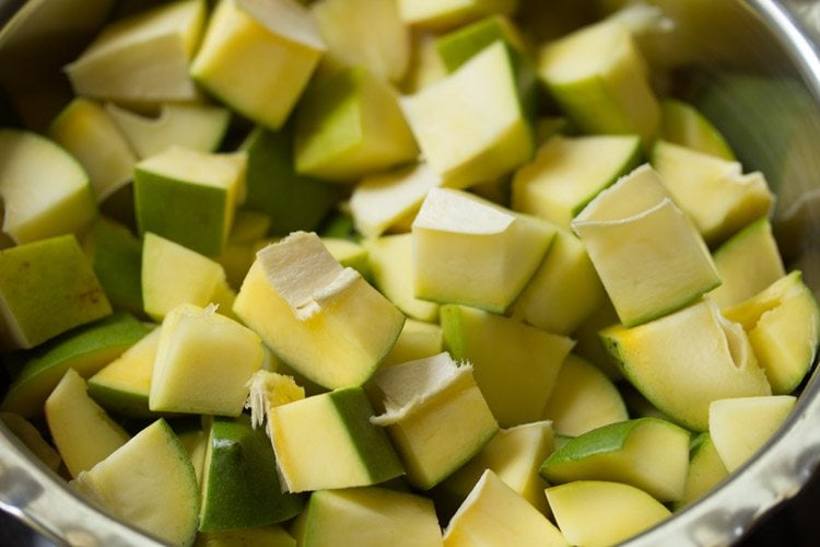 chopped mangoes in a large steel bowl