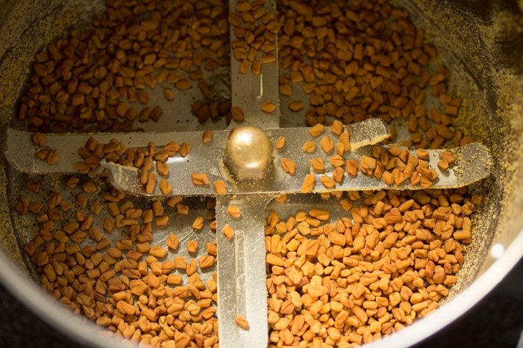 adding sun dried fenugreek seeds to the grinder jar 