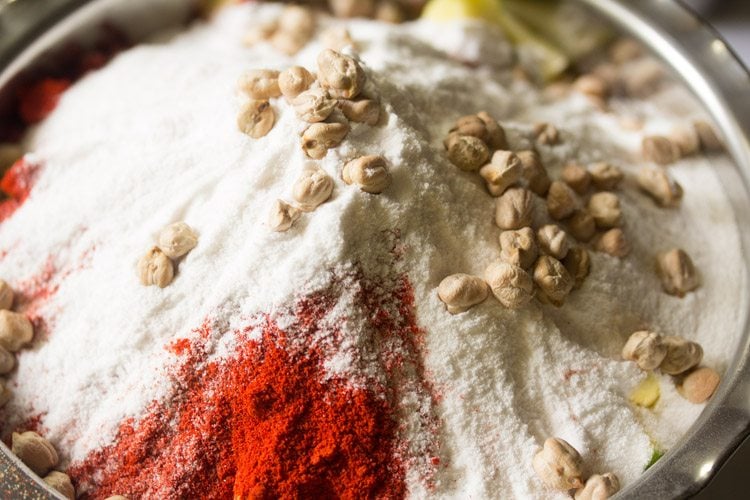 adding white chickpeas and rock salt to the mango pieces 