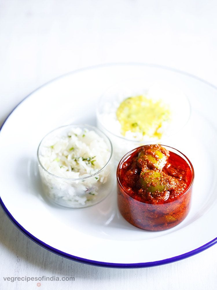 avakaya pachadi served in a bowl with rice in a bowl on a plate 