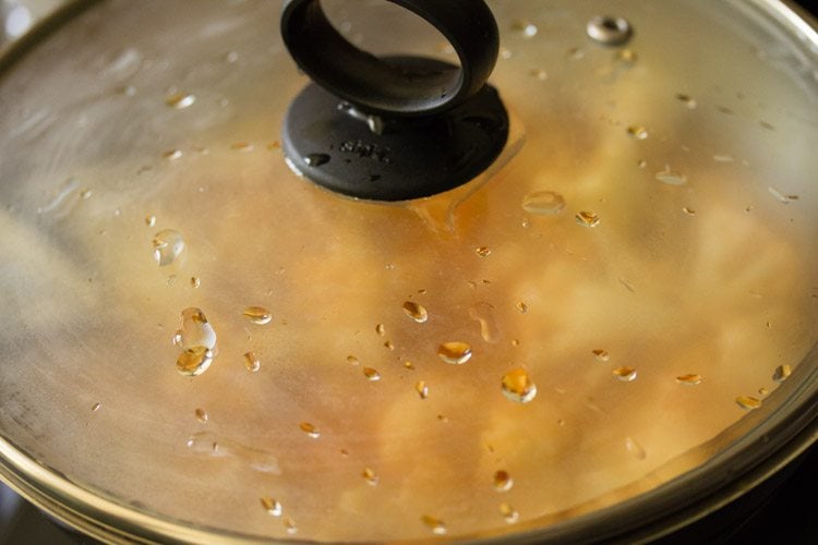 cooking cauliflower curry in covered pan. 