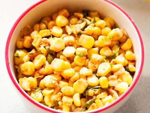 corn salsa served in a dark pink rimmed white bowl