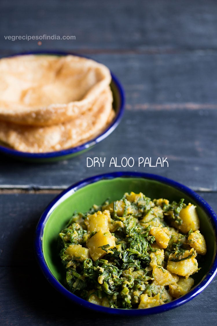palak ki sabji served in a ceramic bowl with a ceramic plate of pooris kept on top left side and text layovers. 