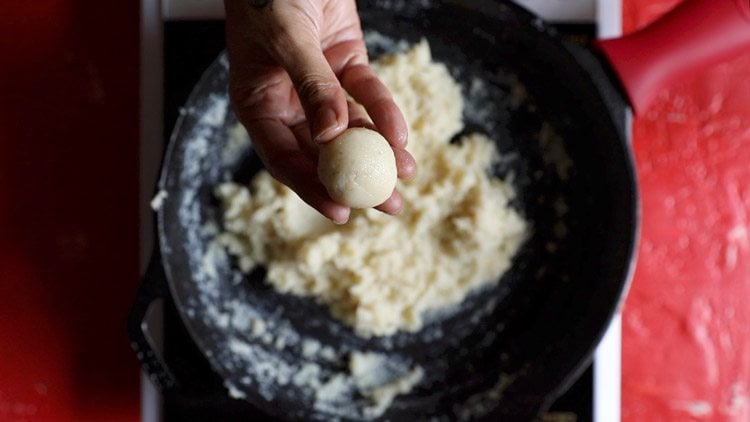 round shaped coconut ball held in fingers