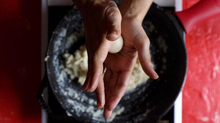 shaping and rolling laddu mixture between palms