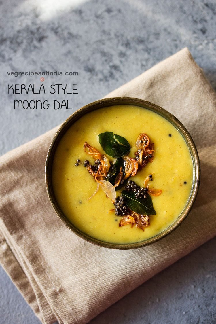 parippu curry served in a ceramic bowl with tempering on top and text layovers. 